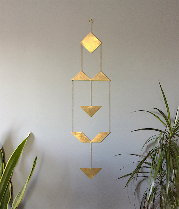 Brass triangle geometric wall hanging by Knuckle Kiss